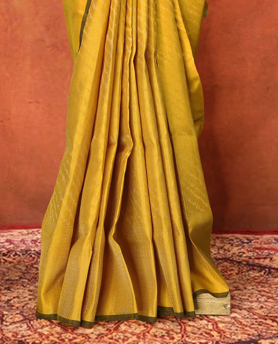 Yellow colour pure Mayuri silk saree featuring finely woven Golden zari motifs across the body, detailed with a subtle geometric self border with intricate texture, with matching blouse