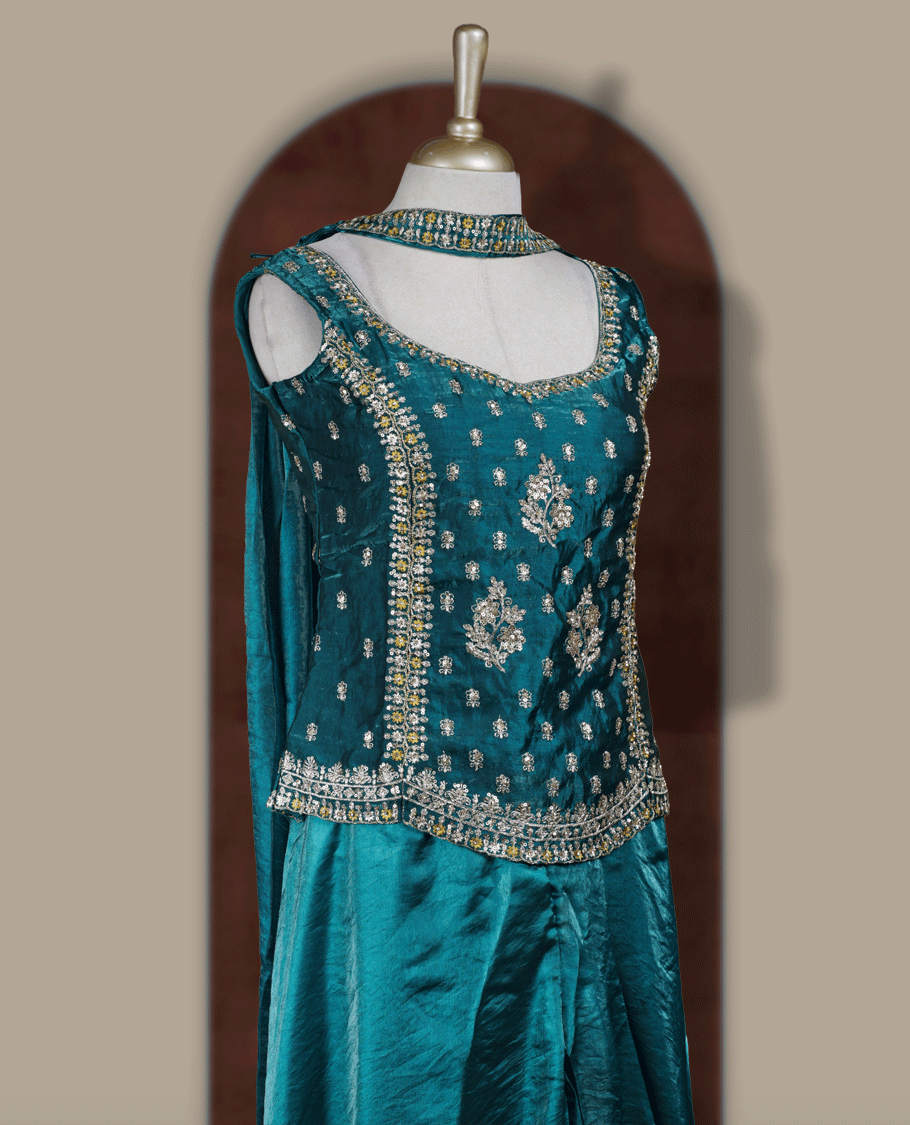 Rich peacock green colour sharara set adorned with intricate light golden embroidery and sequins work & The fitted embellished top pairs beautifully with the flared bottoms and matching dupatta.