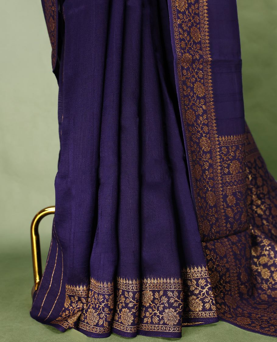 Navy Blue colour Tussar Banaras saree featuring a plain body, rich floral woven zari border and grand pallu, paired with a matching blouse for an elegant and regal traditional look.