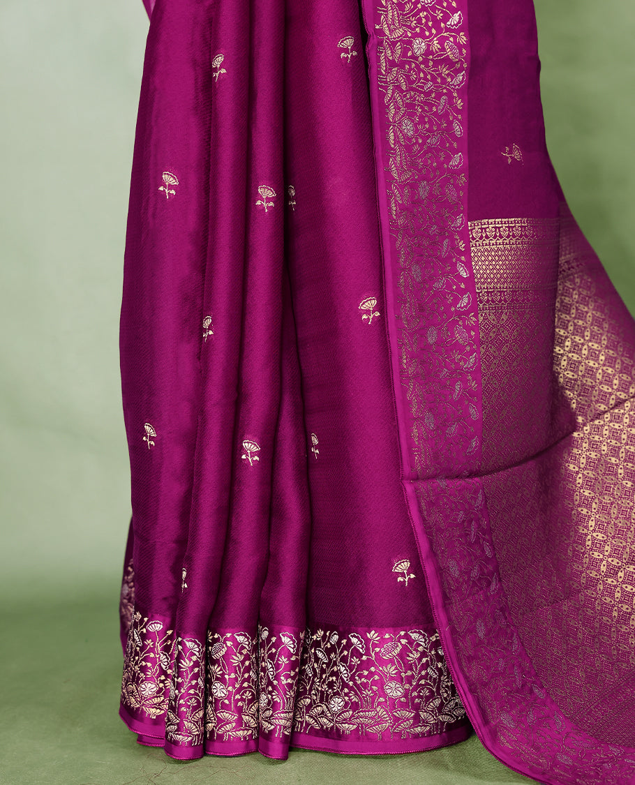 Grape colour pure Banaras crepe saree showcases elegant Gold zari Flower Motifs all over the body, a traditional gold & Silver zari border, a rich intricately woven pallu, and comes with a matching blouse.