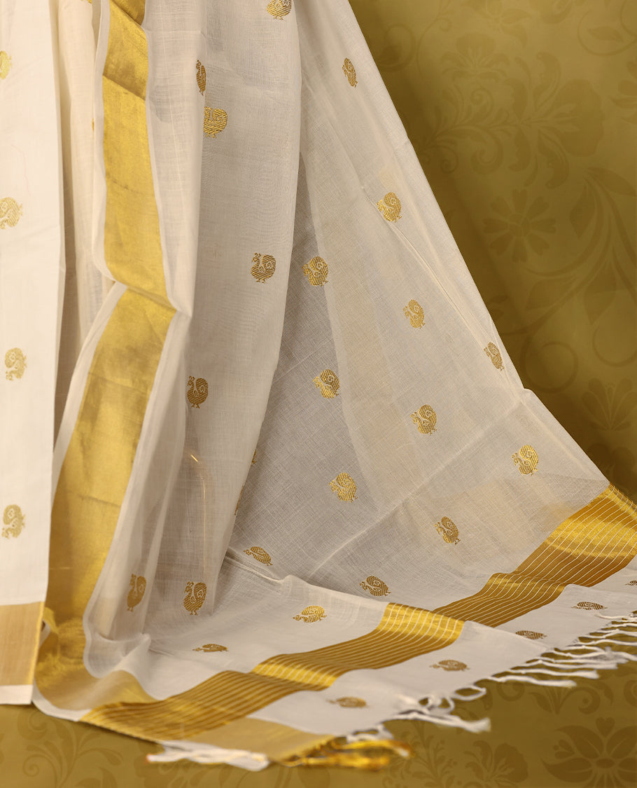 Off white colour pure handloom cotton kerala saree with small gold woven motifs on the body, golden zari border, pallu adorned with gold zari small peacock motifs, with matching blouse