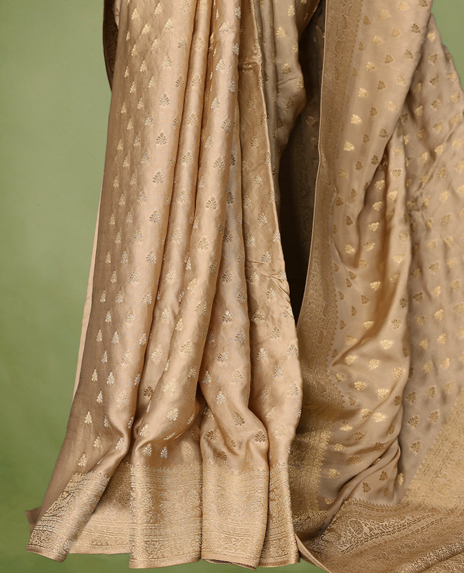 Champagne Gold semi-Banaras satin crepe saree featuring traditional closely woven buttas on the body, complemented by an antique-style border and a matching self-coloured blouse.