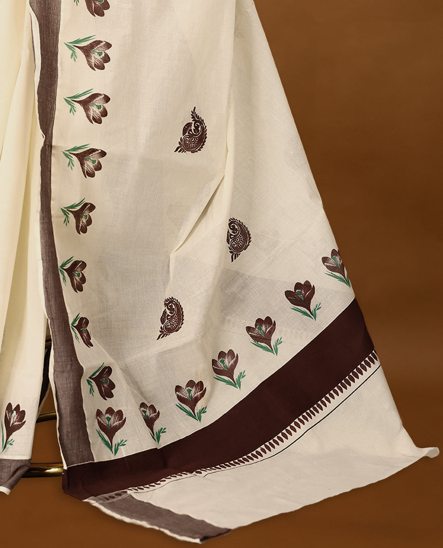Kerala cotton saree features beautiful floral Prints in earthy tones, paired with a deep brown border with Matching Blouse.