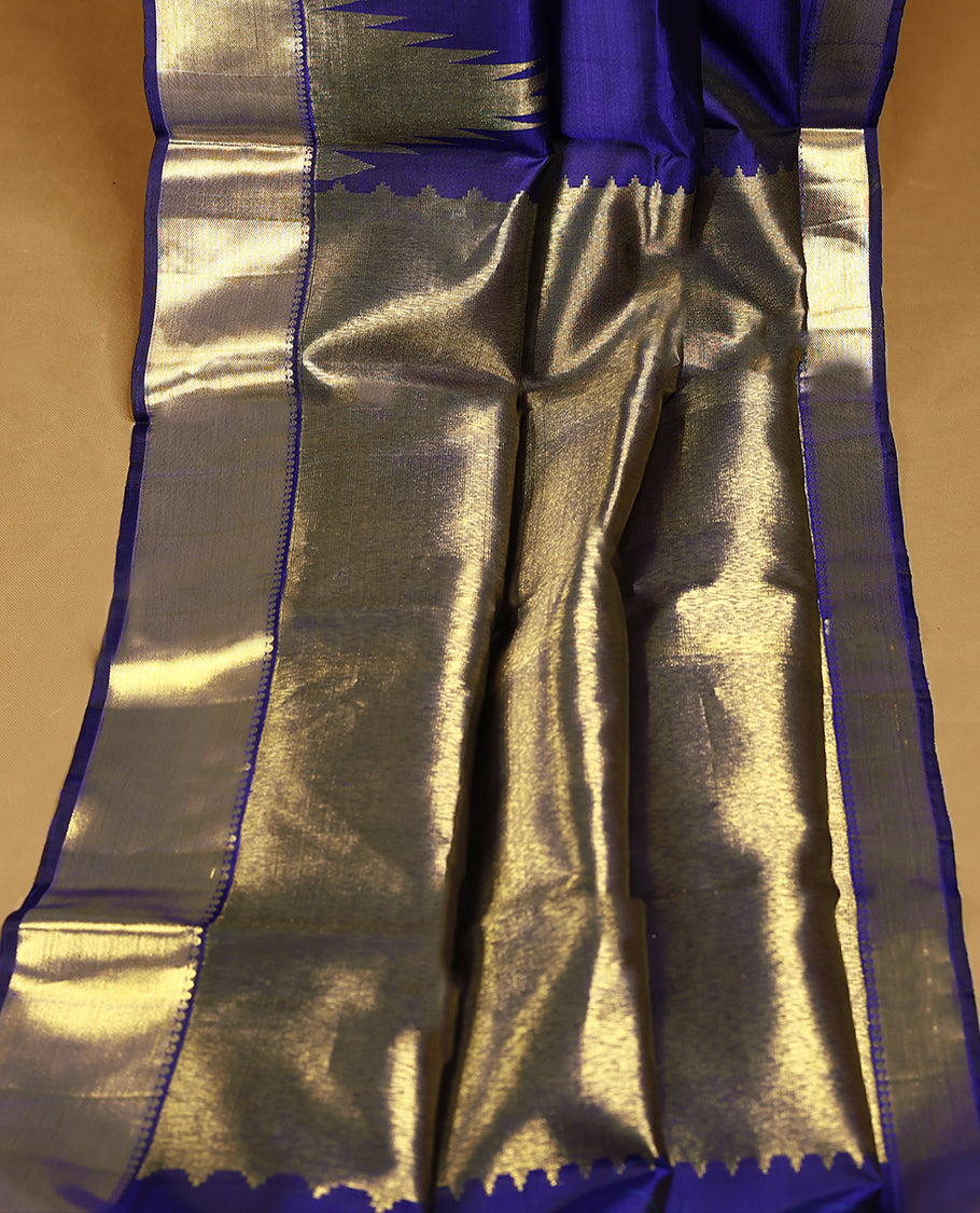 Navy blue pure traditional Kancheepuram silk saree featuring a plain body, complemented by a traditional border adorned with temple motifs, and paired with a matching blouse.