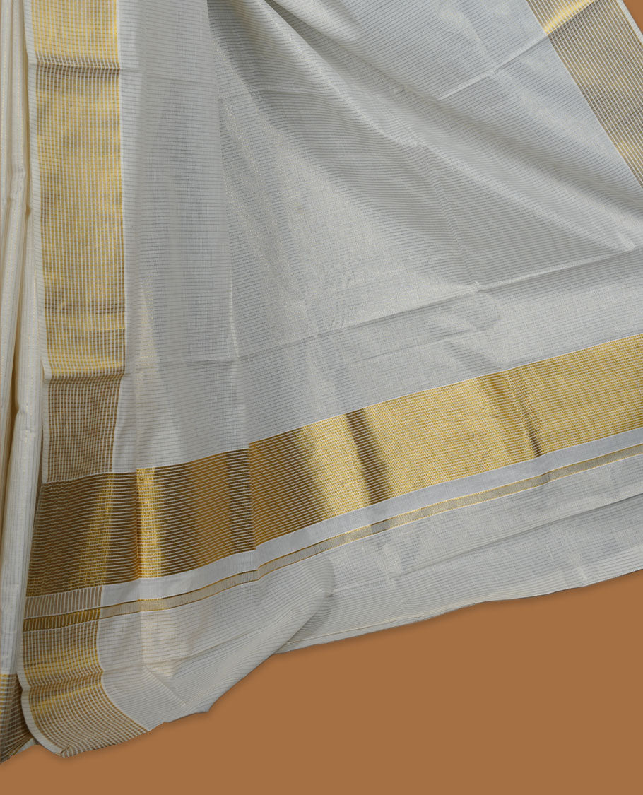 Off white colour Kerala cotton saree featuring fine golden stripes, complemented by a classic zari border and traditional pallu, paired with a matching blouse.