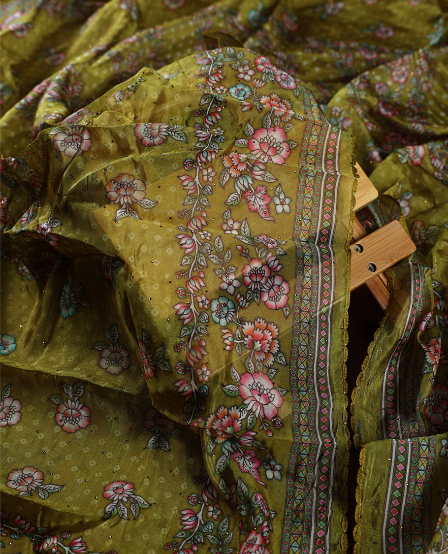 Mustard yellow churidhar material beautifully designed with intricate floral, stone and vine prints, paired with a matching plain bottom and elegant printed dupatta, perfect for festive and traditional wear.