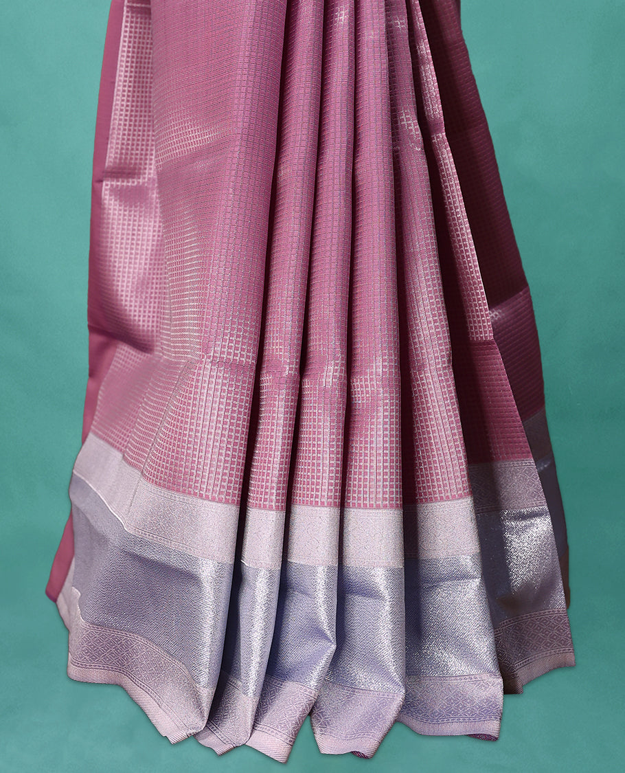 Pastel Onion coloured semi silk saree featuring a Check design on the body, paired with a Baby Blue coloured border and matching blouse.