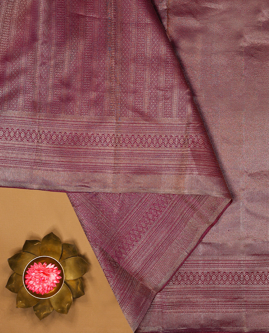 Grape wine Colour Manthrakodi saree featuring an antique zari brocade body, complemented by a self coloured traditional border and a matching self coloured brocade blouse.