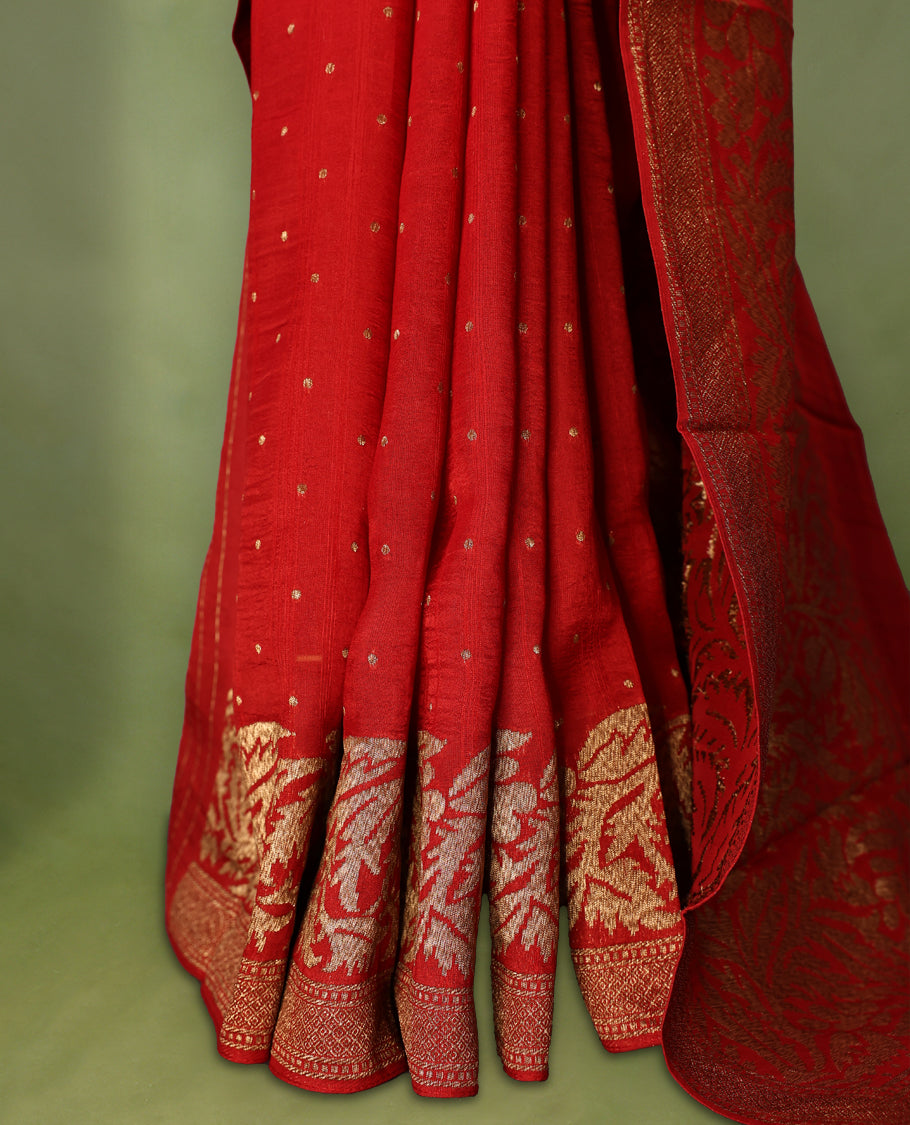 Red colour pure Tussar Banaras saree adorned with delicate golden zari motifs on the body, rich floral woven zari border and grand pallu, paired with a matching blouse for an elegant and regal traditional look.