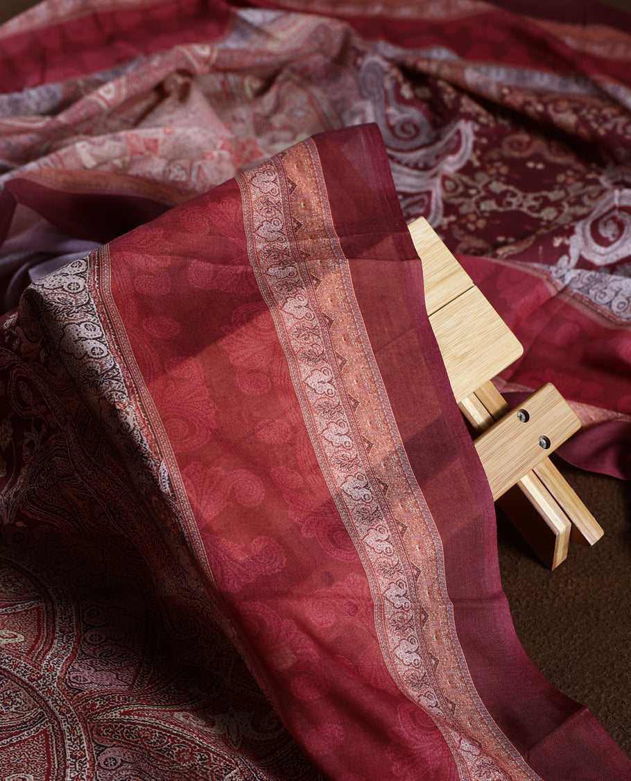 Rich maroon colour churidhar material adorned with elegant embroidery and intricate paisley patterns, complemented by a beautifully printed dupatta and plain bottom.