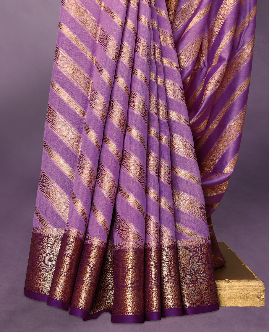 Lavender colour pure Banarasi Chanderi cotton, exquisitely detailed with traditional antique zari Aada designs across the body, finished with a hand-dyed contrast traditional border and a matching blouse.