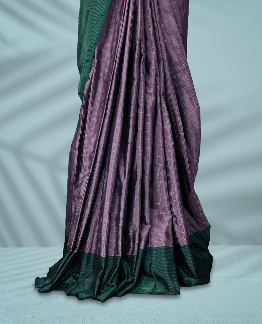 Pastel lavender Colour semi silk saree features a fine checked body design, contrasting deep green textured borders, and comes with a matching blouse.