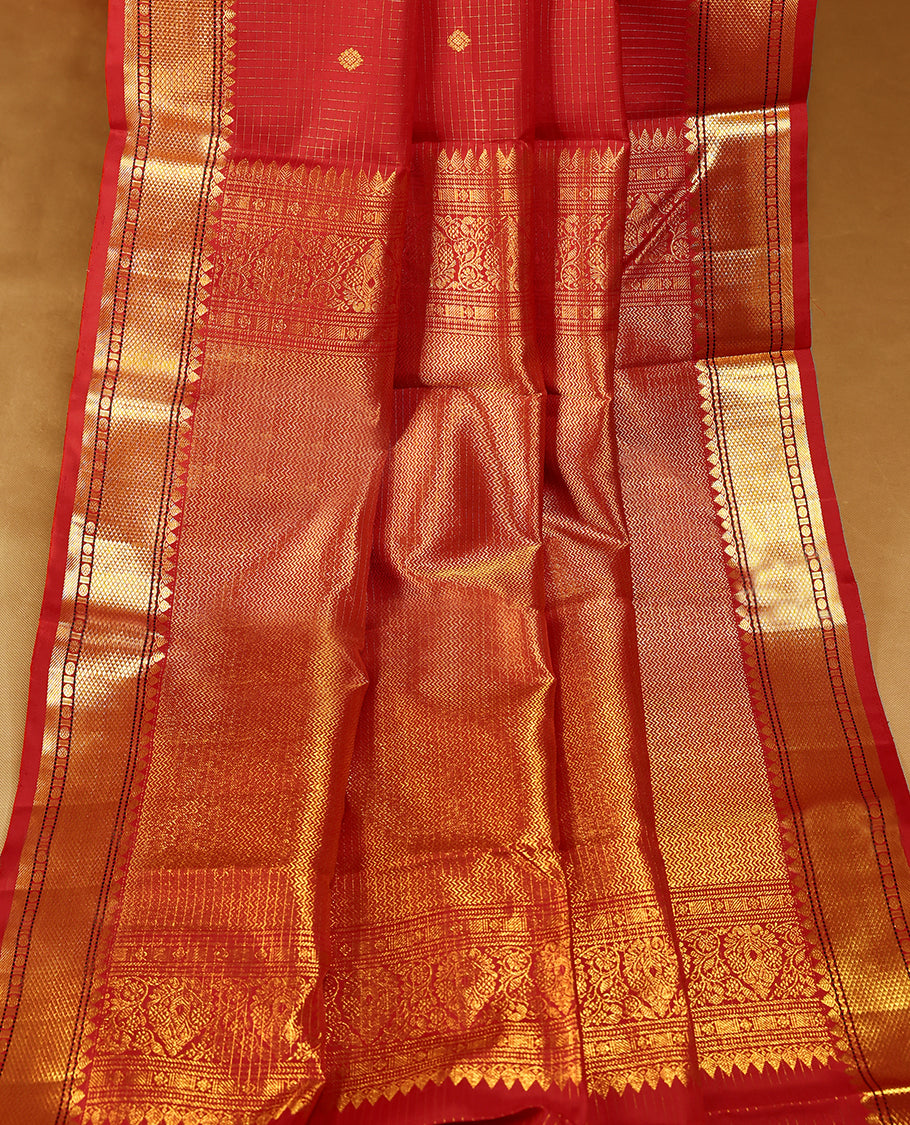 Red traditional Kancheepuram silk saree featuring antique zari check patterns with golden motifs on the body, a classic rudraksham border, and a matching blouse.