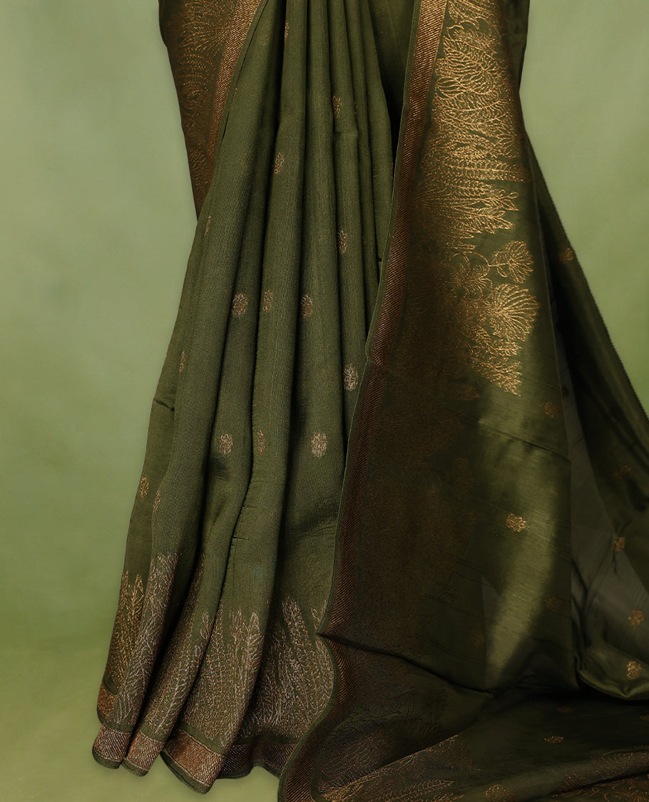 Army Green semi-Banaras tussar georgette saree adorned with antique zari floral motifs on the body, beautifully highlighted with a pencil art garden-inspired border, paired with a matching blouse.