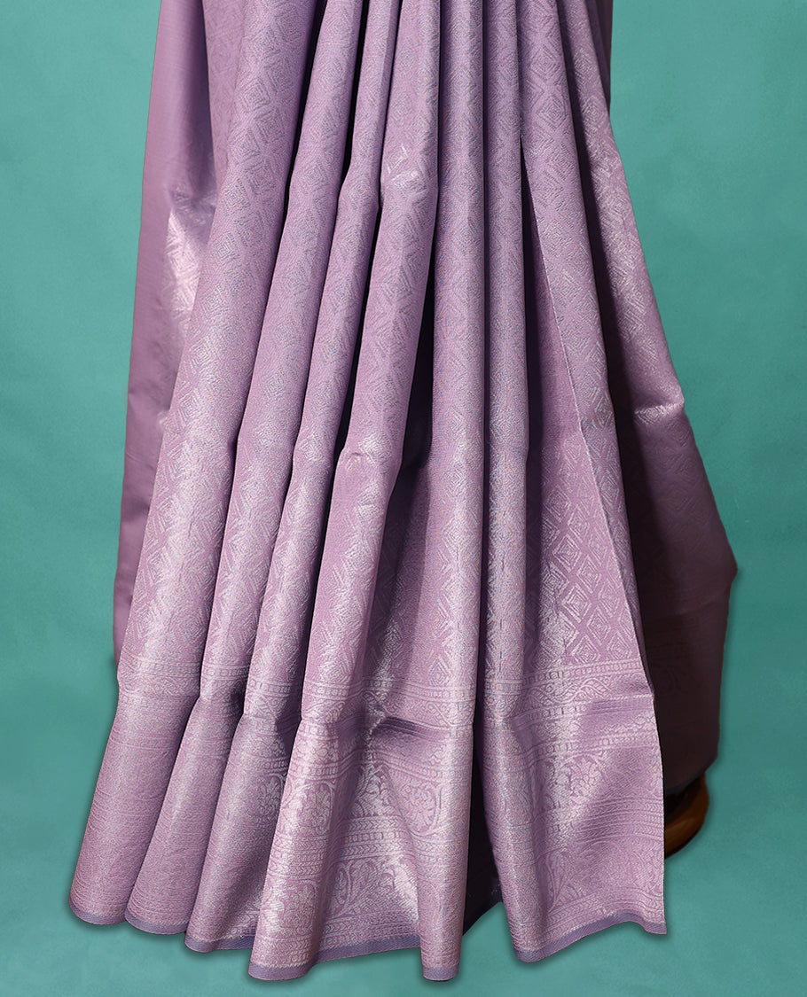 Pastel Purple coloured semi silk saree featuring a Silver coloured Zari Diamond design on the body, paired with a Self coloured border and matching blouse.