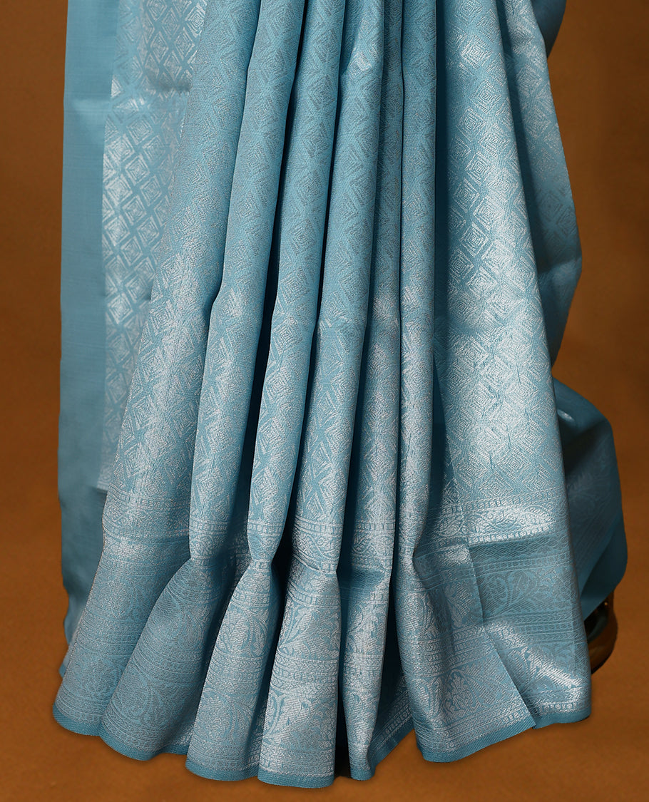 Light Blue coloured semi silk saree featuring a Silver coloured Zari Diamond design on the body, paired with a Self coloured border and matching blouse.