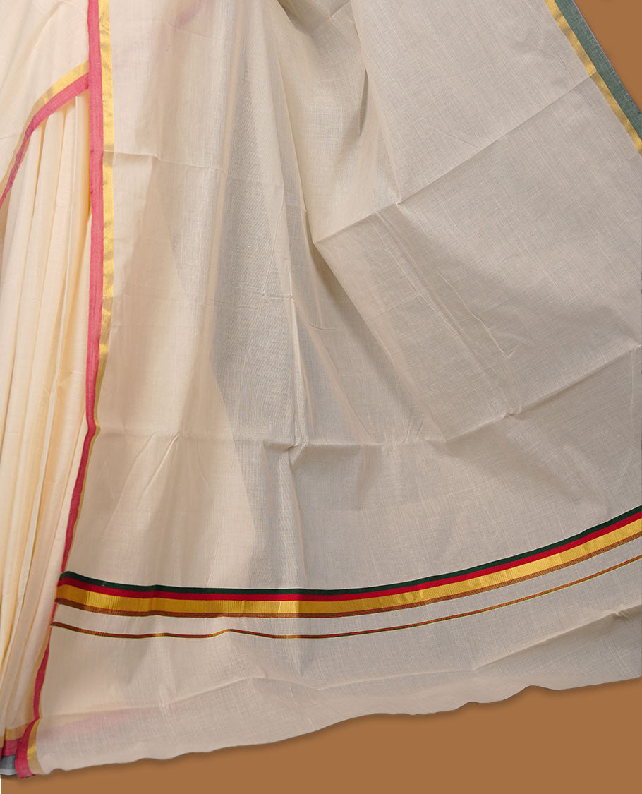 Off-white colour cotton Kerala saree featuring a classic gold kasavu border, accentuated with subtle green and pink contrast edging, a plain elegant body, and paired with a matching blouse.