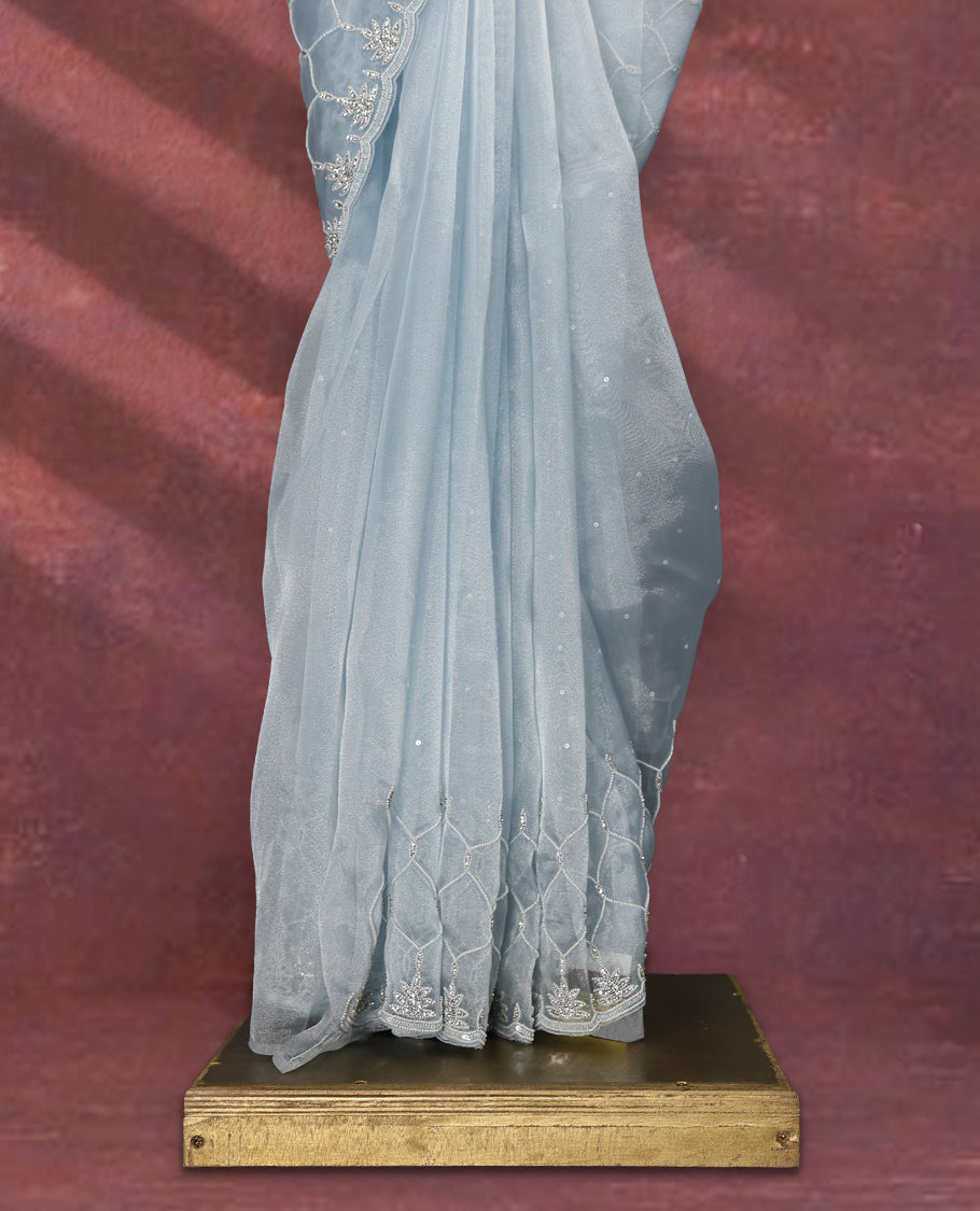Light Pastel Blue colour pure organza saree featuring sequin work all over the body, adorned with a heavily embellished border with beads, stones, and sequins, complemented by a worked pallu and paired with a matching embellished blouse