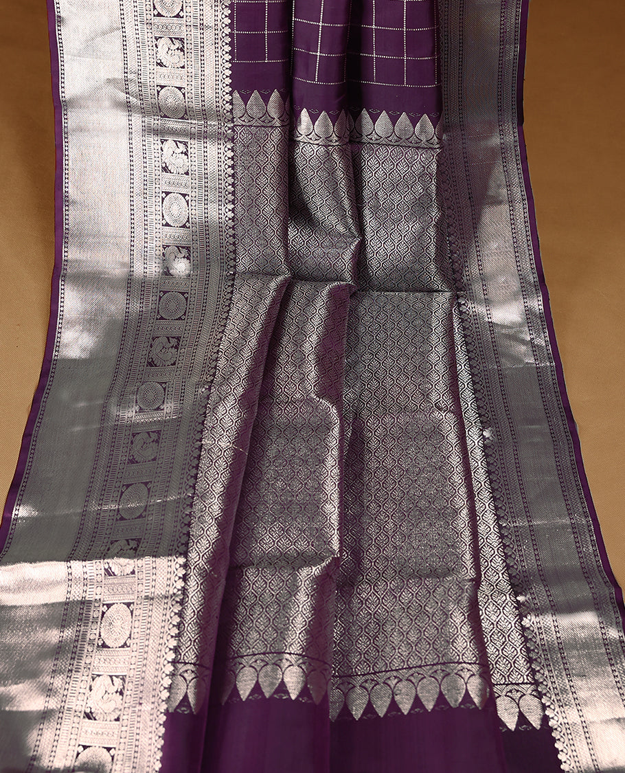 Royal Purple traditional Kancheepuram silk saree featuring antique zari check patterns with peacock and chakkram motifs on the body, a coordinated peacock and chakkram design on the border, and a matching Contrast blouse.