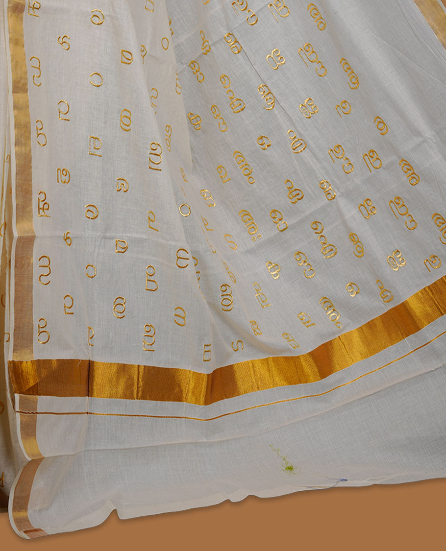 Off-white colour cotton Kerala saree, featuring a classic gold kasavu border and delicate gold-toned Malayalam script motifs woven across the body and pallu. paired with a matching blouse