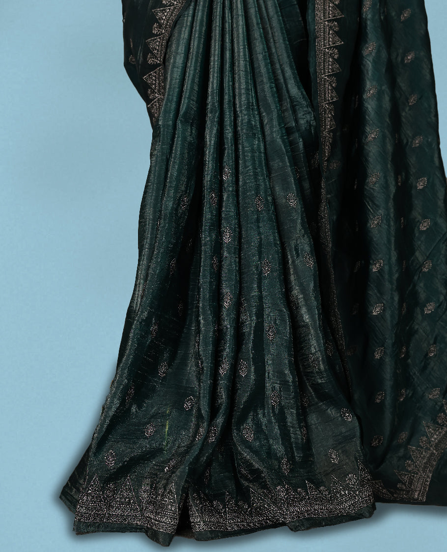 Deep Sea Green Colour crush soft silk saree, textured body with a natural crinkled finish, adorned with intricate Silver colored floral Motifs and complemented by a delicate Silver Zari embroidery border, paired with a matching blouse