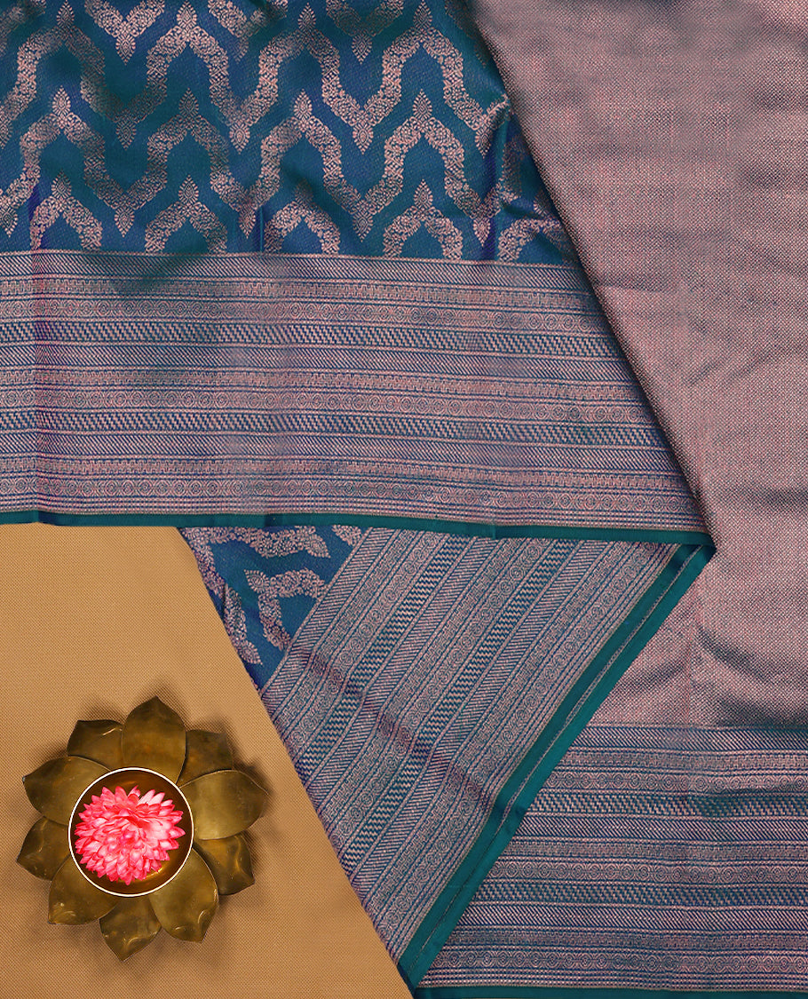 Peacock Blue Colour Manthrakodi saree featuring an antique zari Banarasi design on the body, complemented by a self coloured traditional border and a matching self coloured blouse.