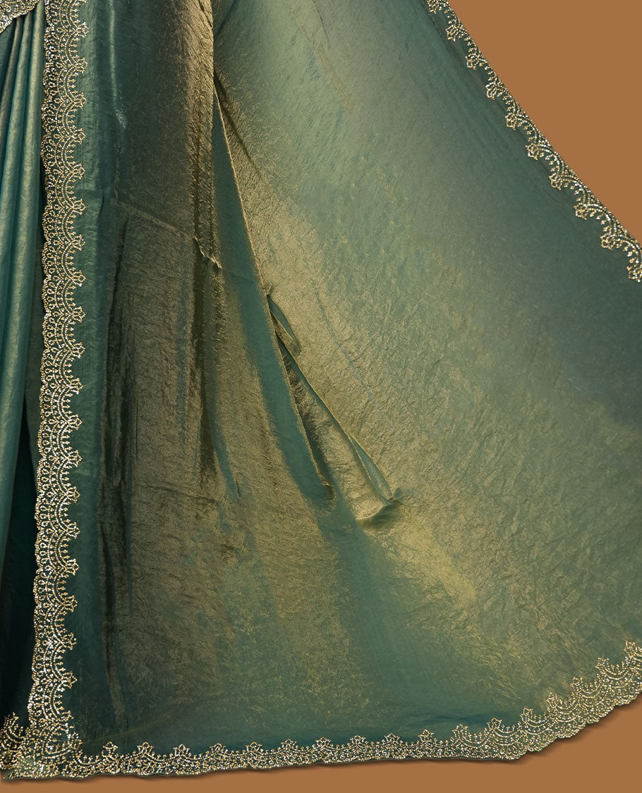 Teal blue with gold colour shimmer fancy saree adorned body, paired with a with delicate gold stone worked border, with matching blouse