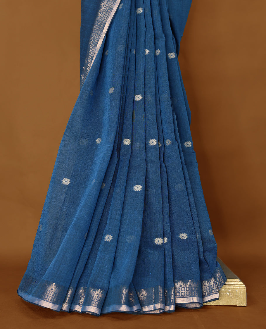 Blue colour soft khadi cotton saree with small Beige Zari Flower motifs on the body, detailed woven Gold zari border, paired pallu with tussles, with matching blouse.