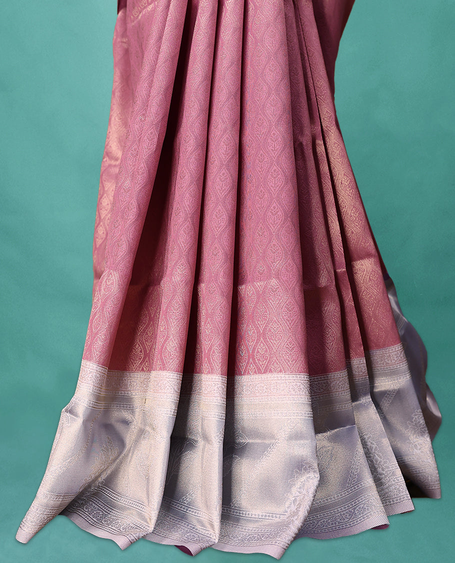 Onion coloured semi silk saree featuring a Brocade body, paired with a Light Pastel Purple coloured border and matching blouse.