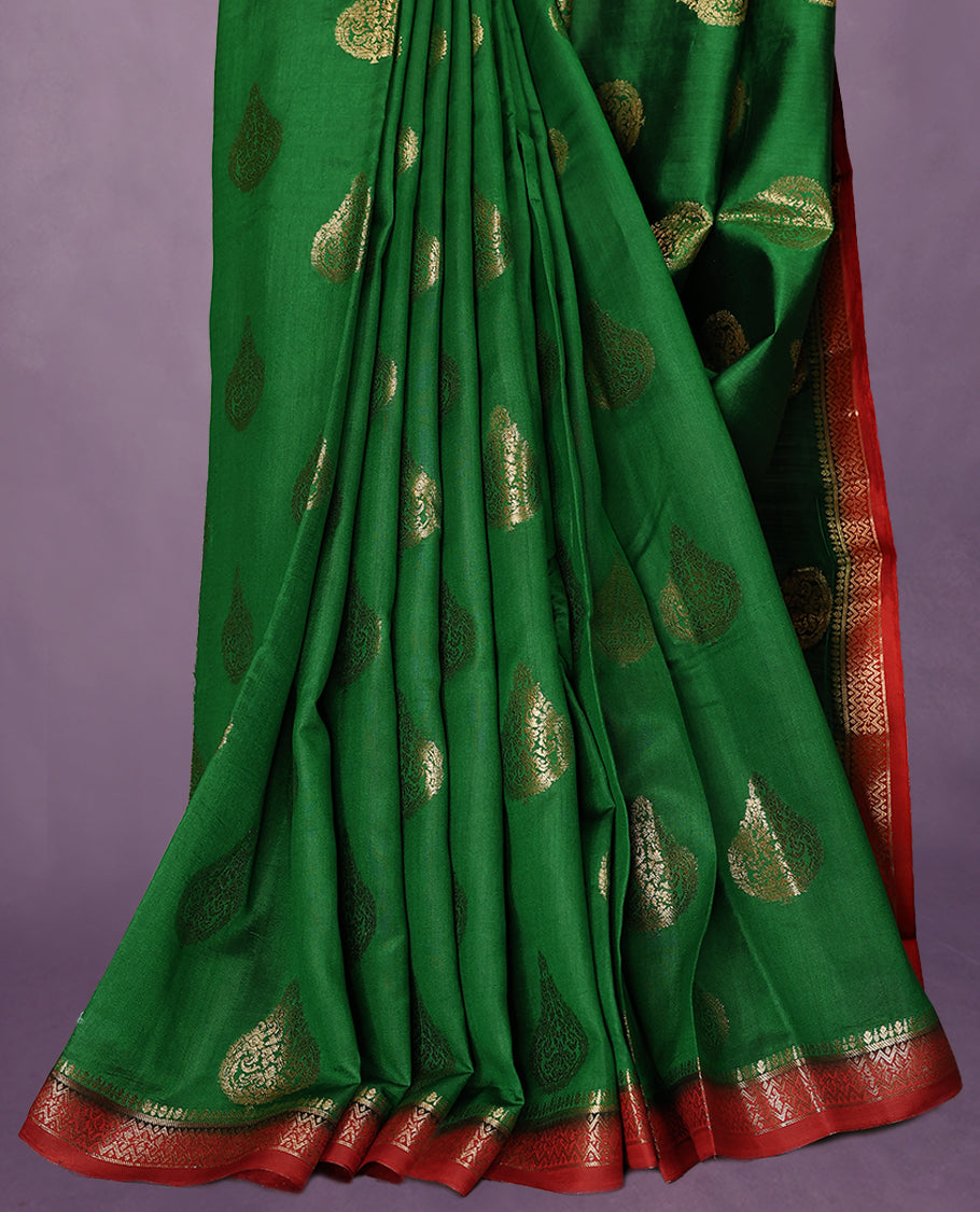 Dark Green Colour Pure Banaras Soft Silk Saree adorned with traditional antique zari motifs, paired with a hand dyed Dark Red antique style border and a matching blouse.