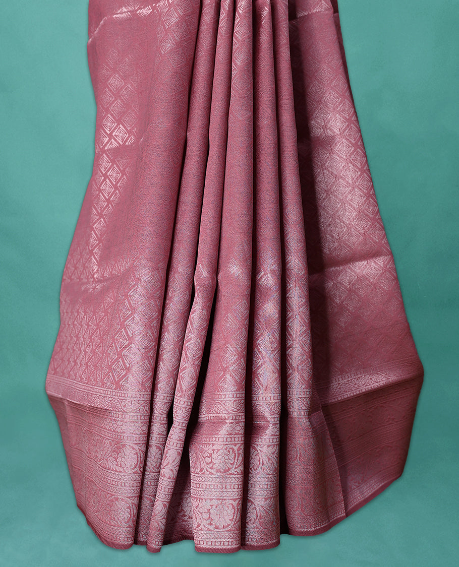 Pastel Onion coloured semi silk saree featuring a Silver coloured Zari Diamond design on the body, paired with a Self coloured border and matching blouse.