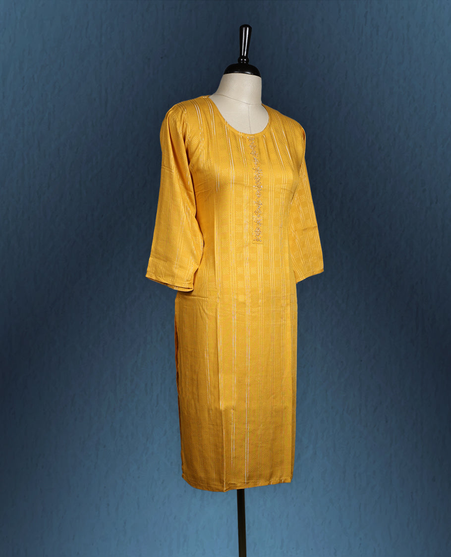 Mustard yellow colour kurti with subtle vertical self stripes, adorned with delicate thread embroidery along the front placket, featuring a round neckline and stylish three quarter sleeve