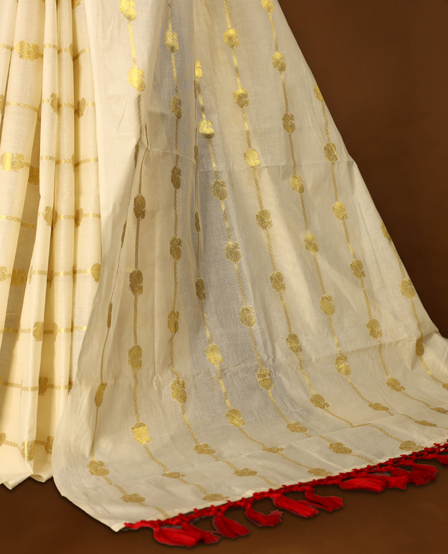 Elegant off white colour cotton Kerala saree featuring a gold Zari stripes with peacock motifs on body, with Red colour tassels offering a classic and graceful look, paired with a matching blouse.