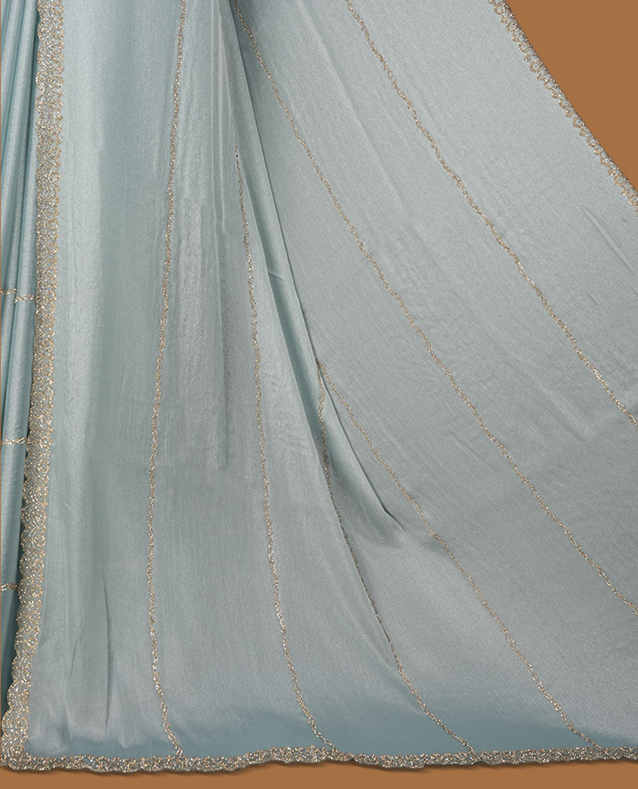 Powder Blue colour net shimmer fancy saree with a plain body, paired with a delicate stone worked border, with matching blouse