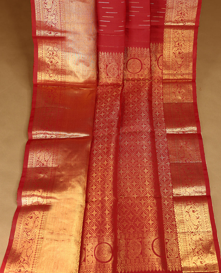 Deep red Colour pure traditional Kancheepuram silk saree adorned with intricately woven antique zari work on the body, complemented by Self colour traditional border featuring elephant, Horse, and Floral Kodi motifs, and paired with a matching blouse.