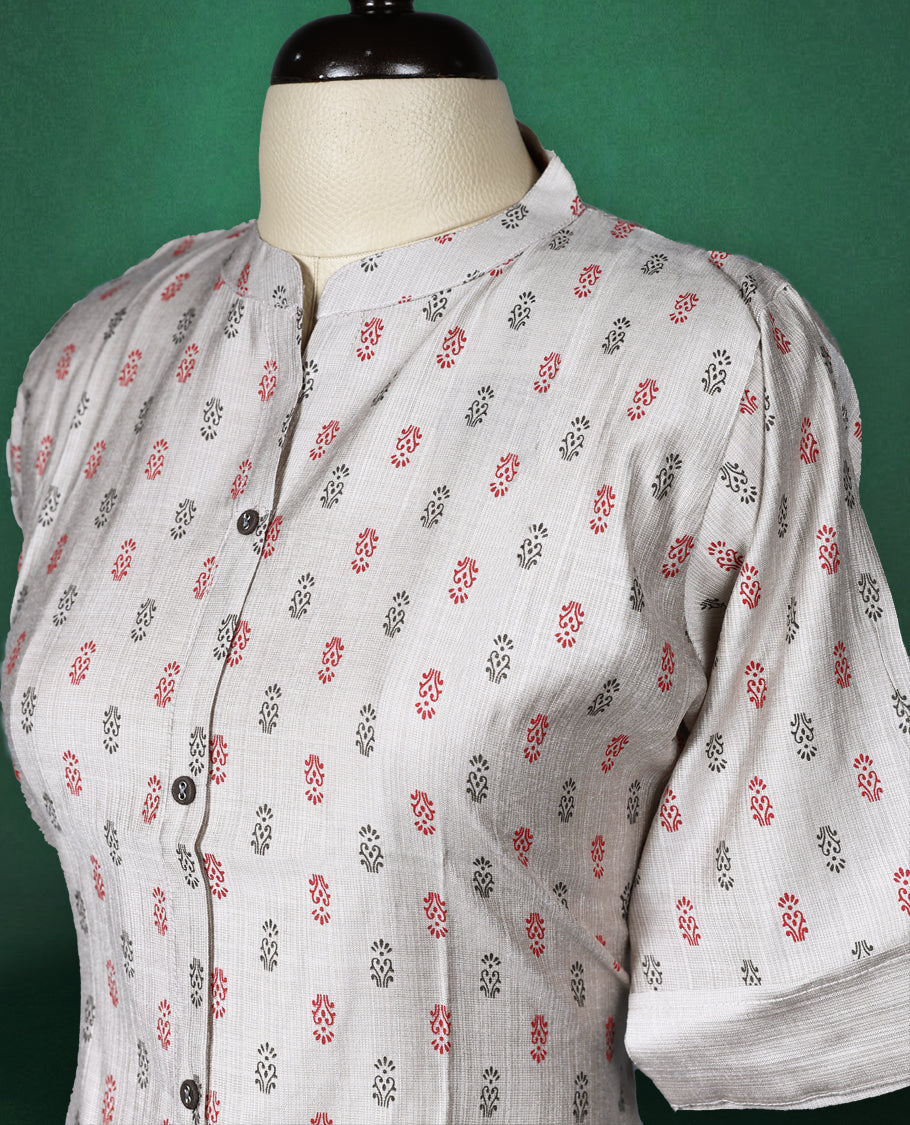 Beige colour cotton kurti with subtle red and grey all-over prints, featuring a mandarin collar, front button placket, and short roll up sleeves, comfortable and stylish choice for everyday wear