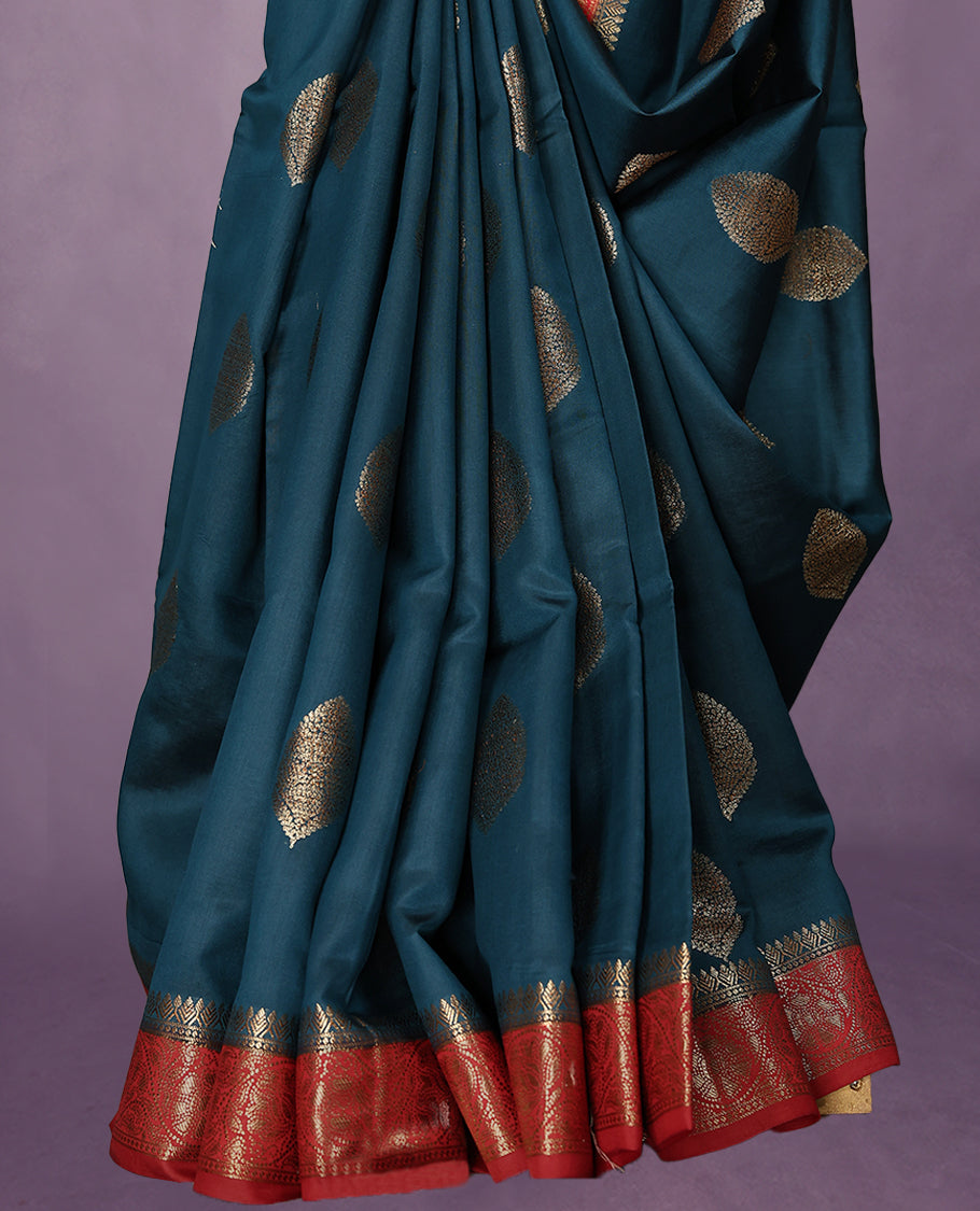 Greman Blue Colour Pure Banaras Soft Silk Saree adorned with traditional antique zari motifs, paired with a hand dyed Chilly Red antique style border and a matching blouse.