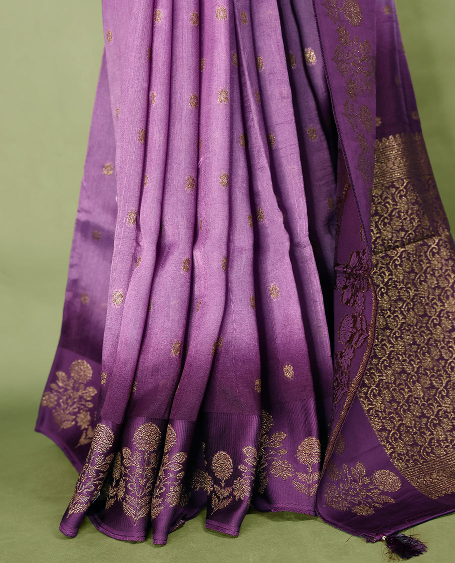Lavender and purple double shade semi Banaras Tussar Georgette saree adorned with elegant antique gold zari floral motifs across the body, featuring a detailed woven border and grand pallu, paired with a matching blouse piece.