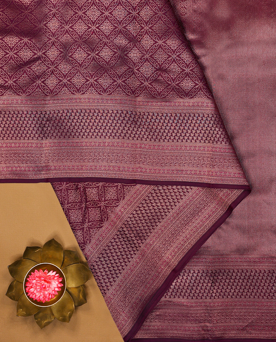 Mulberry purple Colour Manthrakodi saree featuring Antique Zari geometric brocade pattern on the body, complemented by a brocade border and a matching self coloured blouse.