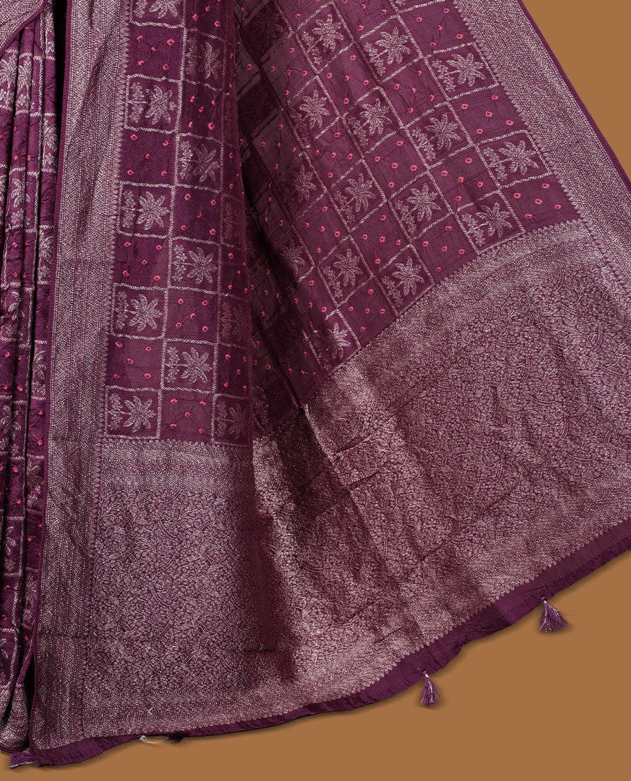 Deep dark purple colour Banarasi Bandhani silk saree featuring with intricate Banarasi motifs on body, complemented by antique zari woven border and grand pallu, paired with matching blouse