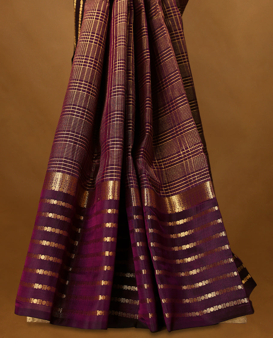 Grape wine Colour soft silk saree adorned with golden zari checks on the body, complemented by a self-coloured border featuring a golden zari Poun design, paired with a matching self-coloured blouse