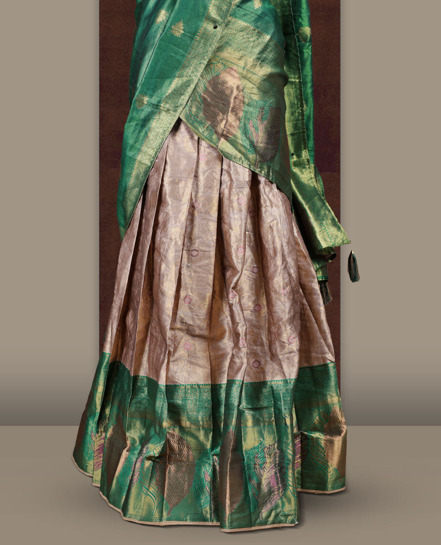 Gold and Green colour Dhavani set featuring a Gold colour skirt with contrast Green colour border with rich gold zari pattern, paired with a contrasting Green dupatta detailed with gold motifs
