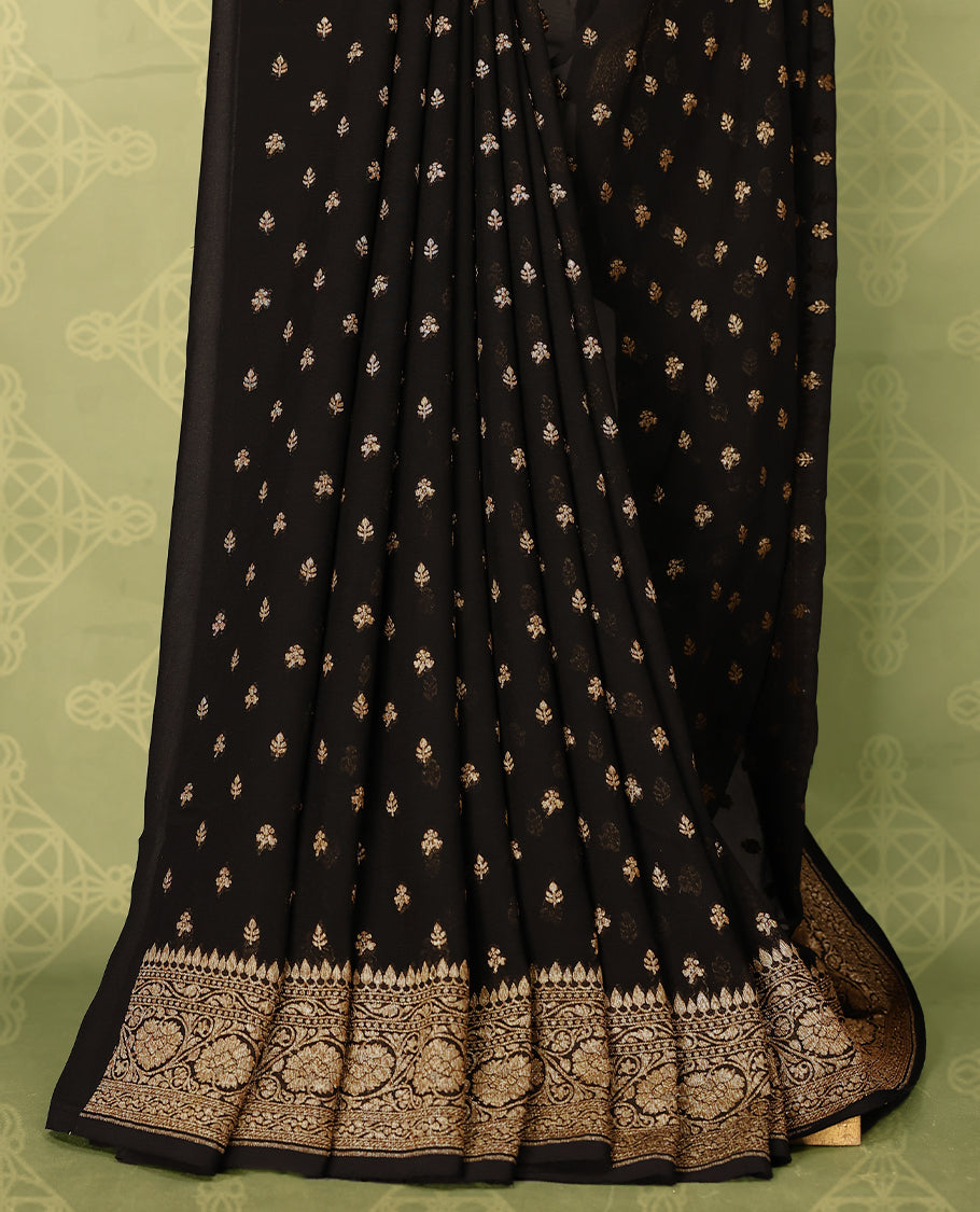Black colour pure Banarasi georgette saree featuring gold zari Flower Motifs all over the body, complemented by an intricate gold zari Floral Kodi Worked border and pallu, with matching blouse.