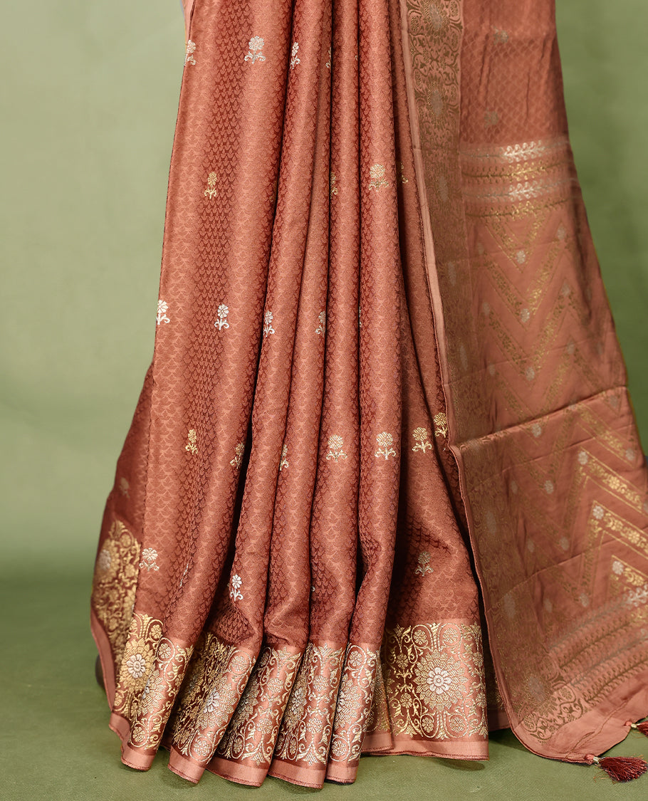 Pastel Brown colour pure Banaras crepe saree showcases elegant silver zari Flower Motifs all over the body, a traditional Banarasi gold zari border, a rich intricately woven pallu, and comes with a matching blouse.