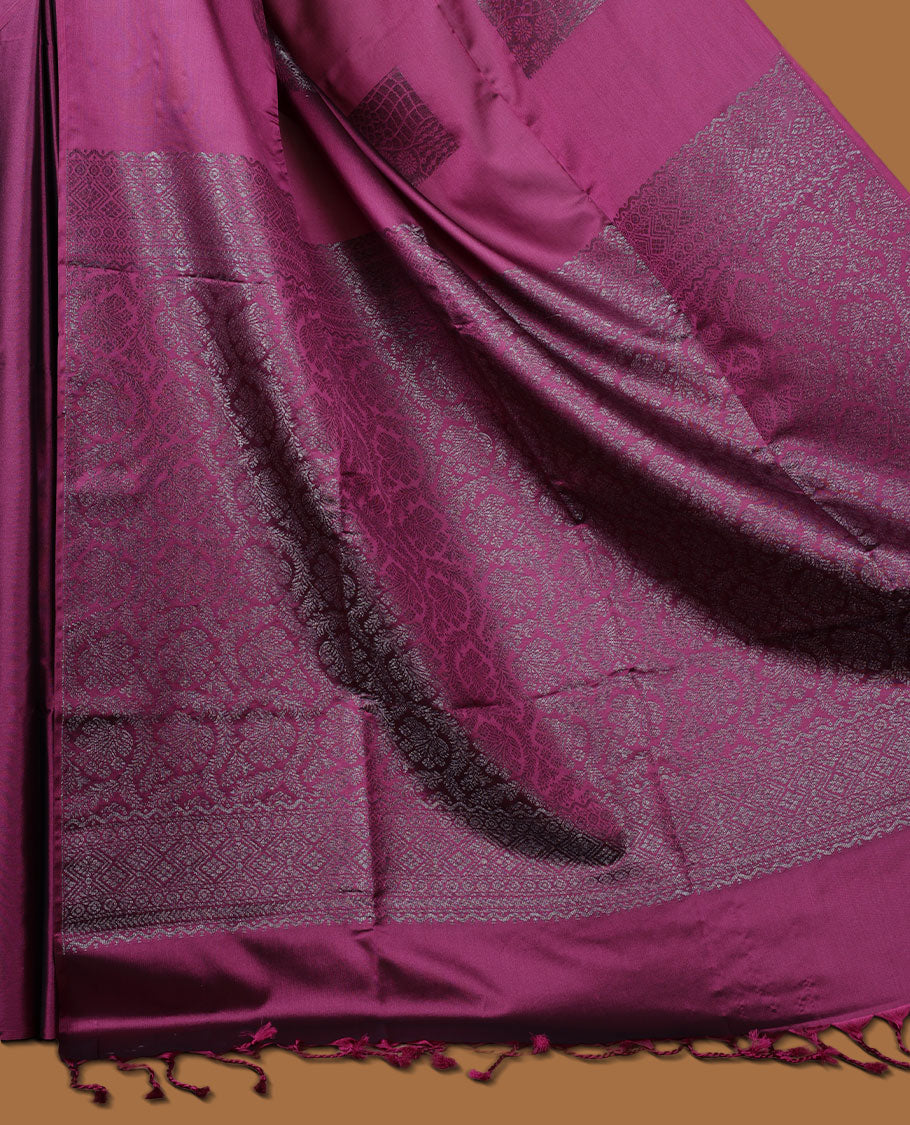 Deep purple colour semi soft silk saree adorned with delicate woven Square motifs on the body, complemented by a Self colour woven pallu with intricate detailing and tassel accents without border & Comes with a matching blouse piece.