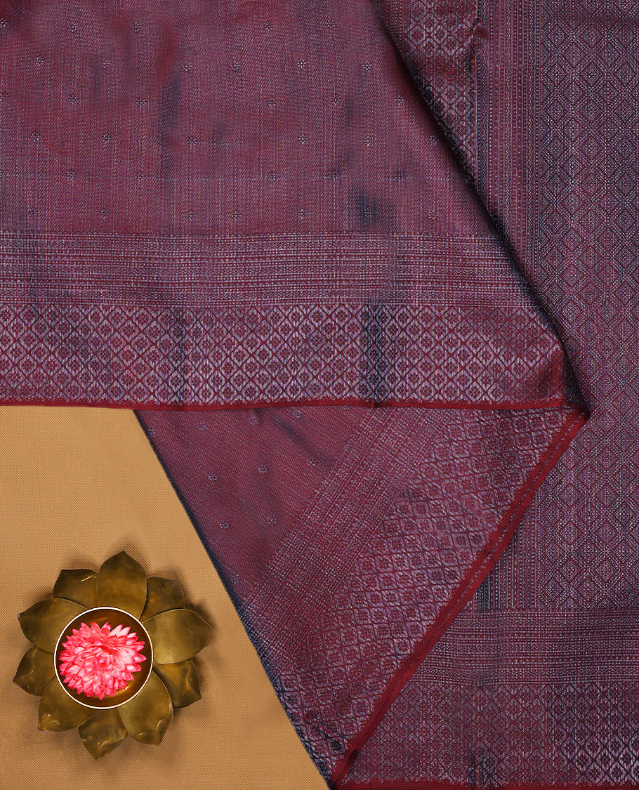Maroon coloured Manthrakodi saree featuring a multicoloured zari jacquard body, complemented by a self coloured turning Banarasi border and a matching self coloured blouse.