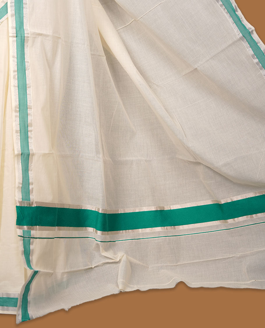 Off-white colour cotton Kerala saree featuring a crisp white body with a refreshing green kasavu border, detailed with subtle silver accents along the edges, and paired with a matching blouse.