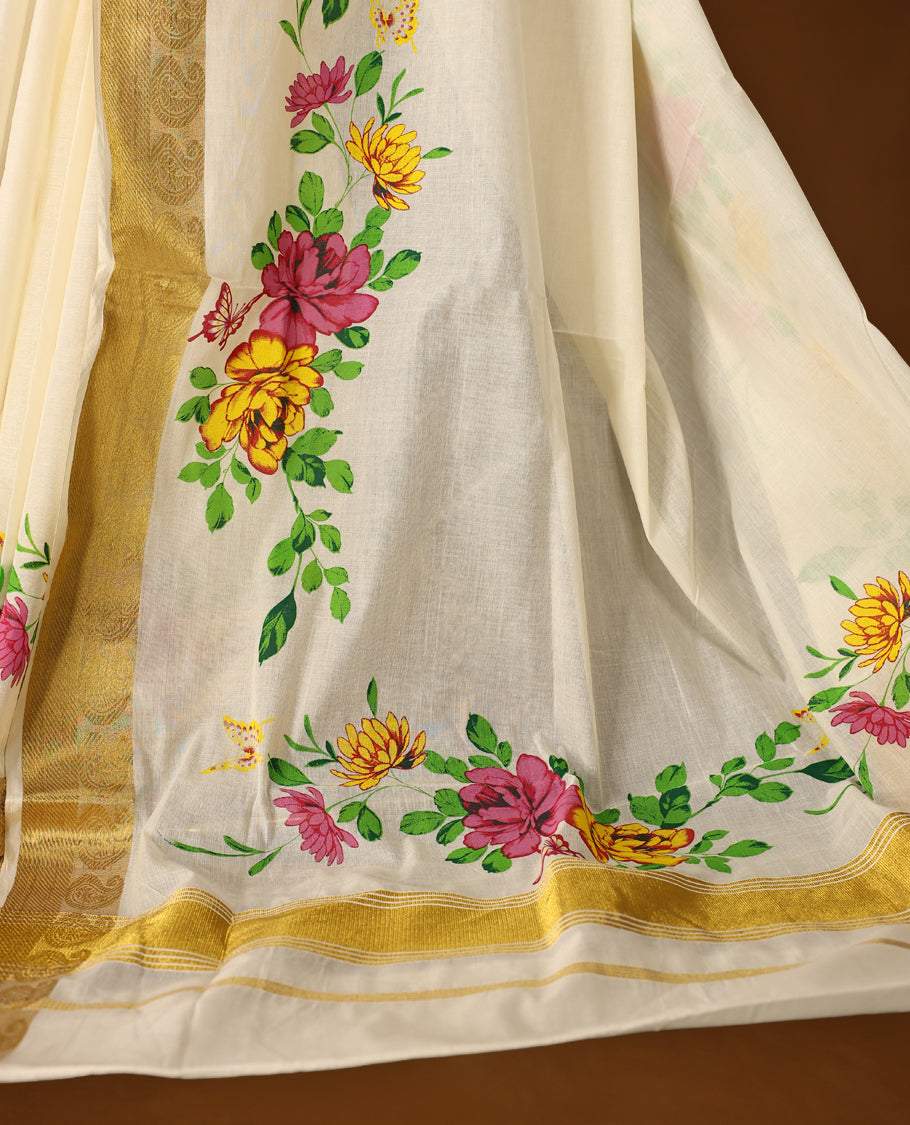 Elegant off white cotton Kerala saree adorned with hand painted floral motifs in pink, yellow, and green, beautifully accented by a rich golden zari border and pallu paired with matching blouse