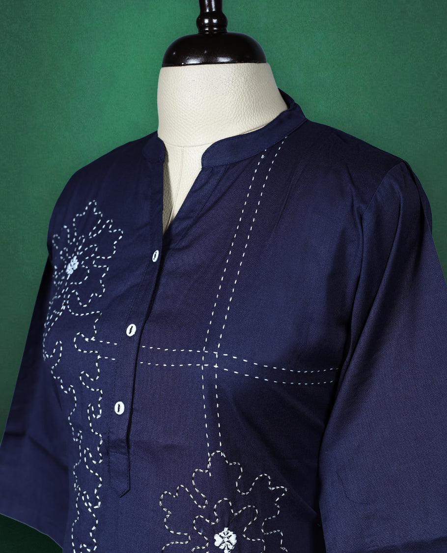 Navy blue colour kurti crafted from soft cotton, featuring a band collar with a buttoned placket, three quarter sleeves, and delicate thread embroidery with floral and dotted patterns for an elegant everyday look.