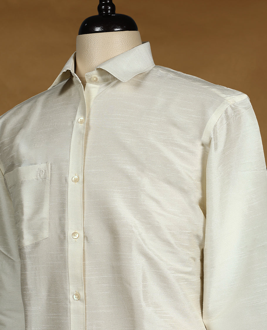 Off White colour DH men's shirt crafted from semi silk fabric, featuring a smooth glossy finish, classic collar, full sleeves, and a chest pocket perfect for festive and traditional wear.